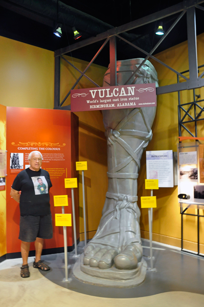 Lee Duquette beside a model of Vulcan's foot